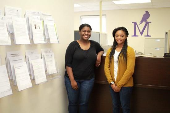 Montevallo student employees standing in front of a desk.